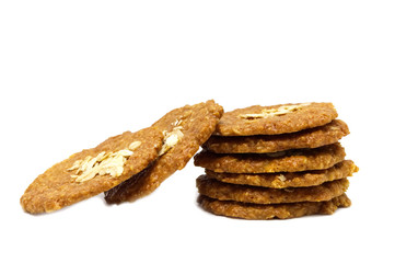 Biscuits homemade Oatmeal flavoured and Thin style. Stack of crunchy delicious sweet meal and useful cookies. Isolated on white background.