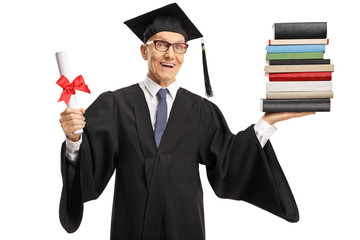 Elderly male graduate with a diploma and a pile of books smiling at the camera