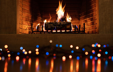 Christmas burning fireplace and lights, holiday decoration background