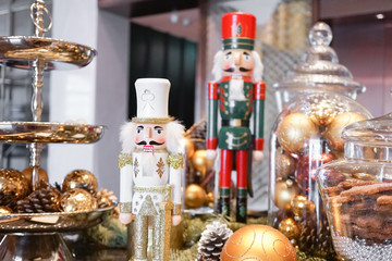 Nutcracker. Vintage wooden nut crackers for festive season during Christmas and New Year with selective focus on the Nutcracker in the white uniform.
