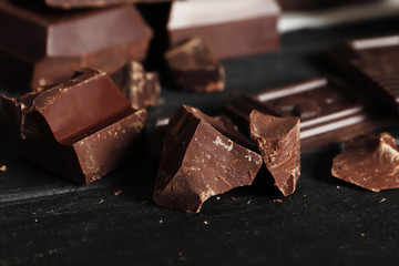 Dark chocolate pieces and bar close-up. Top view. Place for text.
