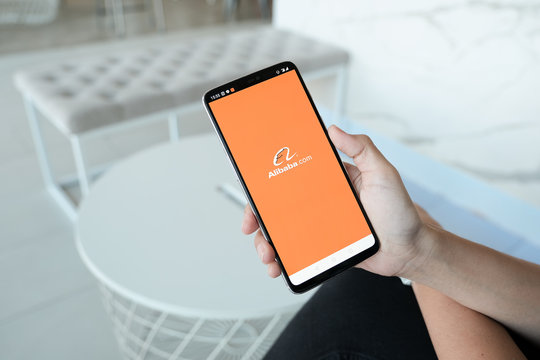 CHIANG MAI, THAILAND - Dec 1,2019: Man hands holding Oneplus a with alibaba apps on screen. Alibaba the the world biggest online commerce company. Its thAree main sites Taobao,Tmall and Alibaba.