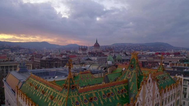 Amazing roof in Budapest, Hungary. State Treasury building with Hungarian Parliament in winter time.  All tiles on the roof made from the world famous Zsolnay pyro granite.
