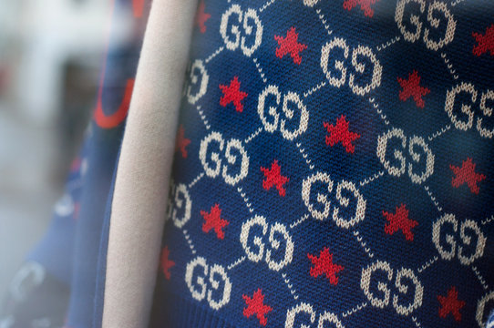 Mulhouse - France - 15 December 2019 - Closeup of Gucci logo on blue pullover in luxury fashion store showroom
