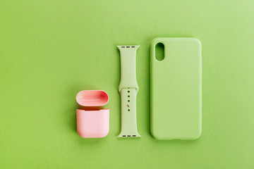 Up to date technology.Top view of diverse personal accessory laying on the green background