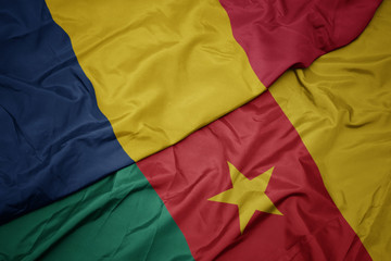 waving colorful flag of cameroon and national flag of chad.