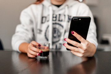 woman writes message to mobile phone