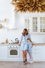 Mother with her kids in the kitchen to xmas, casual lifestyle photo series in real life interior