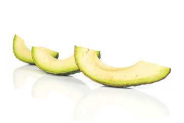Group of three slices of fresh green avocado isolated on white background