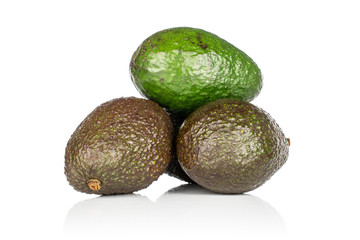 Group of three whole fresh green avocado heap isolated on white background