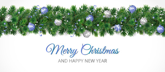 Christmas banner with Merry Christmas text and pine tree garland isolated on white. Blue and silver ornaments. © Olga Prozorova