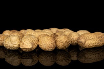 Lot of whole tasty beige peanut isolated on black glass