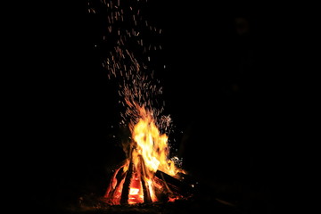 Bonfire with sparks and strong fire at night