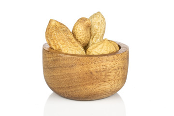 Lot of whole tasty beige peanut in bamboo bowl isolated on white background