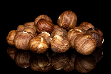 Lot of whole tasty brown hazelnut heap isolated on black glass