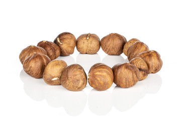 Lot of whole tasty brown hazelnut ring isolated on white background