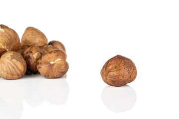 Lot of whole tasty brown hazelnut isolated on white background