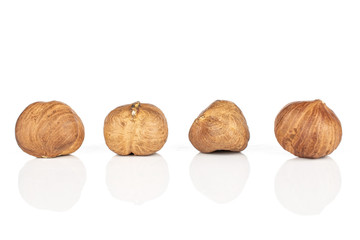 Group of four whole tasty brown hazelnut isolated on white background