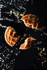 Flying broken butter cookies. Crushed cookie levitation. Food wallpaper. Vertical orientation