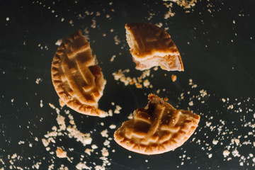 Crushed cookie levitation. Flying broken butter cookies. Food wallpaper. Copy space. Crushed cookie...