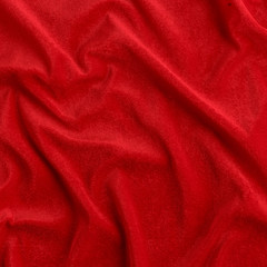 Wavy red silk, atlas or veil fabric, crumpled with creases, bended in spiral wrinkle
