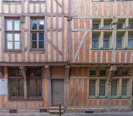 Fototapeta na wymiar Troyes, France - 09 08 2019: Typical street with half-timbered facades