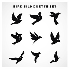 Set of flying birds sign logo vector silhouettes isolated on white