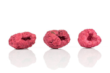 Group of three whole dried raspberry isolated on white background