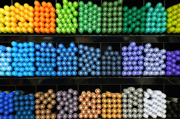 A lot of markers are on the shelf in the store. Color spectrum of markers.