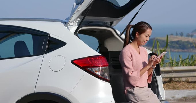 Woman check on the smart phone at road trip