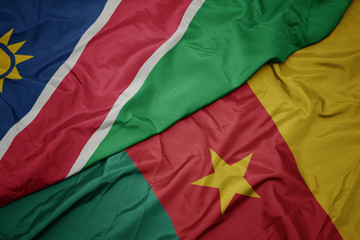 waving colorful flag of cameroon and national flag of namibia.