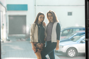 Bisexual relationship lesbian young caucasian teenage girls on the street in summer day. Lesbian couple love story. LGBT community. - obrazy, fototapety, plakaty