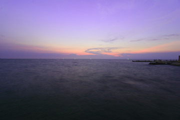 The beautiful light of the sunset at the sea. Mae Ramphueng Beach, Taphong Subdistrict, Mueang Rayong District, Rayong Province, Thailand