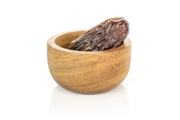 One whole dried brown date fruit in bamboo bowl isolated on white background