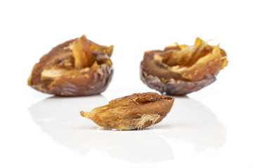 Group of two halves one piece of dried brown date fruit isolated on white background