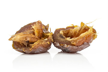Group of two halves of dried brown date fruit isolated on white background