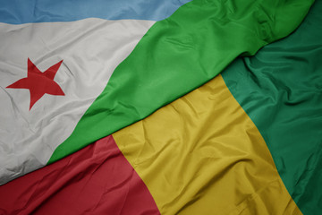 waving colorful flag of guinea and national flag of djibouti.