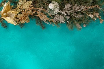 New Year and Christmas gold leaves and flowers decorations, top view. Christmas background with Abstract glitter blinking golden flowers. Winter Christmas or New Year gold metal glittering Xmas card