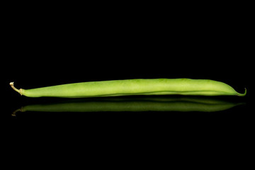 One whole snap green bean isolated on black glass