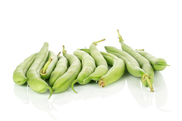 Lot of whole snap green bean pods isolated on white background