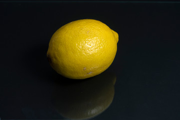 lemon with reflection isolated on black background