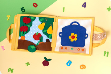CHILDREN'S TEXTILE TRAINING BOOK. A TOY GARDEN WITH TREES AND A GARDEN WITH VEGETABLES ARE MADE FROM FELT AND PAN