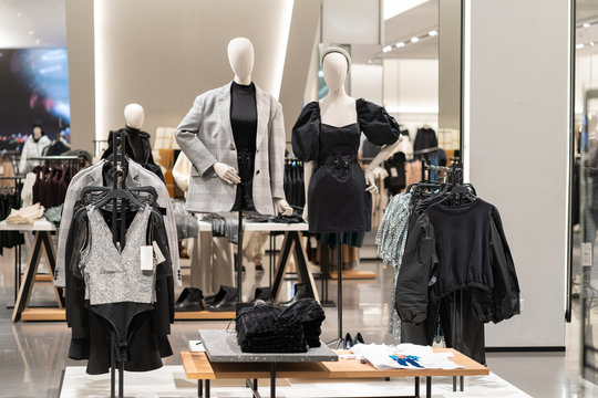 The interior of a fashion store of women's clothing of a famous brand. Mass market. Brand clothes. All things are laid out neatly on the shelves in the closet. Wardrobe order.