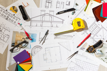 Architectural project, blueprints, blueprint rolls, ruler and pencil. Construction background.
