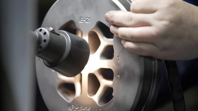 Engineer checks quality die for aluminium metal profiles production. Production of Complex lightweight extruded aluminium metal profiles, commonly used as material in construction and manufacturing