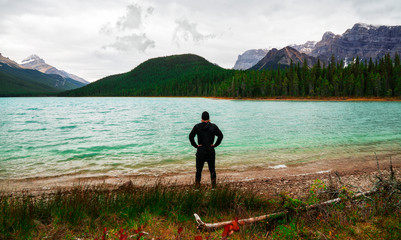 Man Viewing Scenic Lake In Mountains