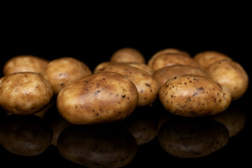 Lot of whole tiramisu brown almond nut isolated on black glass