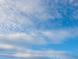 Naklejka na ściany i meble Clouds on a blue sky background. Caucasus