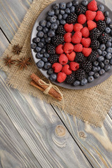 Fresh sweet ripe berries for the winter table for a healthy diet! Rustic style, wooden background, top view, with copy space