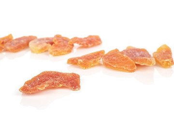 Lot of whole dried orange papaya piece front focus isolated on white background
